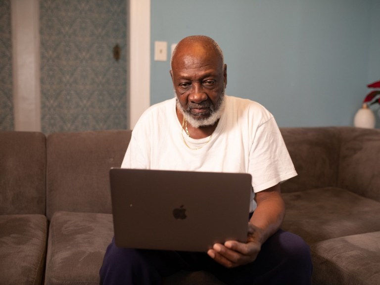 man-wearing-white-crew-neck-t-shirt-sitting-while-using-older man grandfather computer pexels