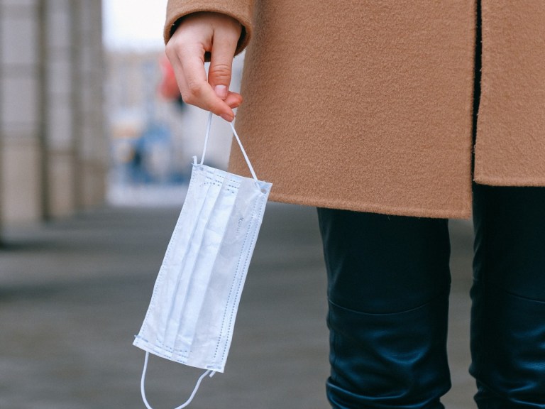 woman-holding-face-mask_pexels