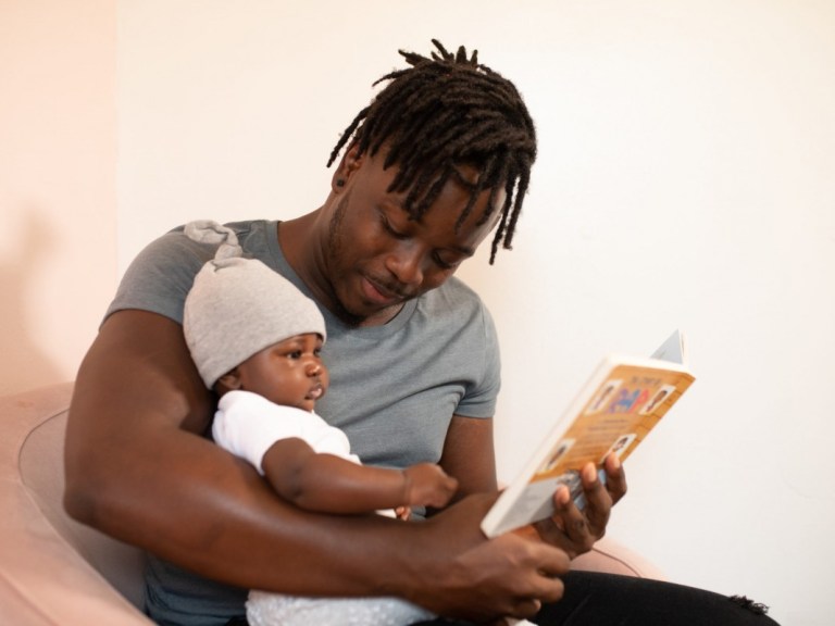 black man reading to baby-Pixel